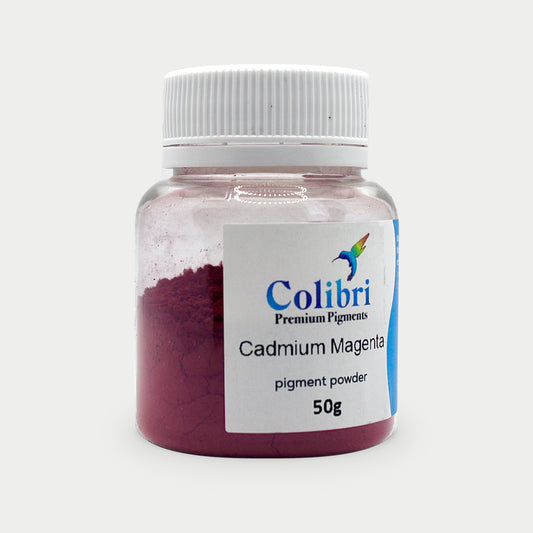 Cadmium magenta pigment powder in a Colibri jar