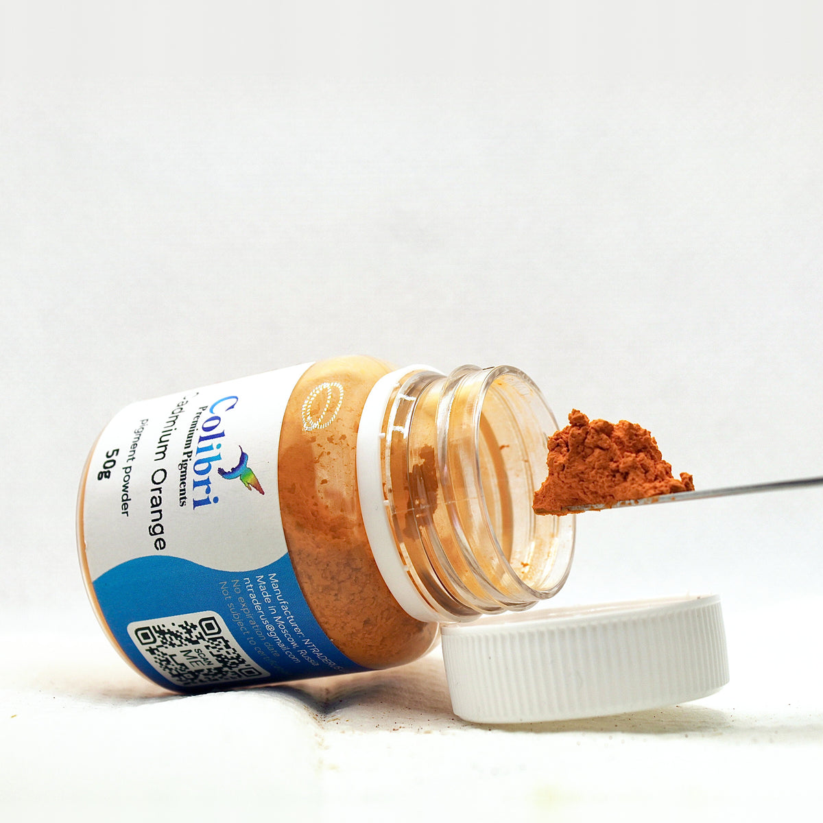 Cadmium orange pigment powder, open jar