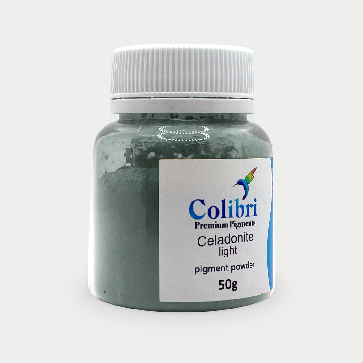 Celadonite light pigment powder in a Colibri jar