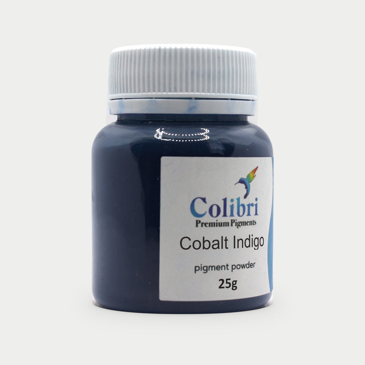 Cobalt indigo pigment powder in a Colibri jar