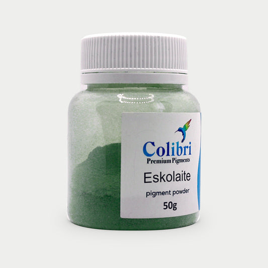 Eskolaite pigment powder in a Colibri jar