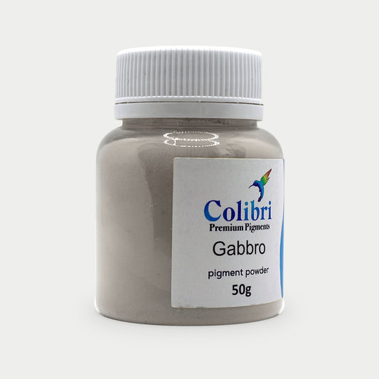 Gabbro pigment powder in a Colibri jar