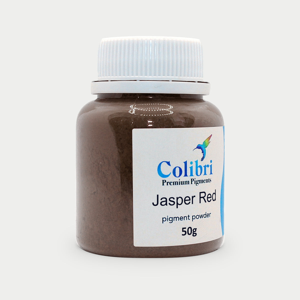 Jasper red pigment powder in a Colibri jar