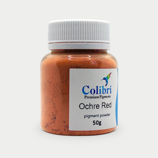 Ochre red pigment powder in a Colibri jar
