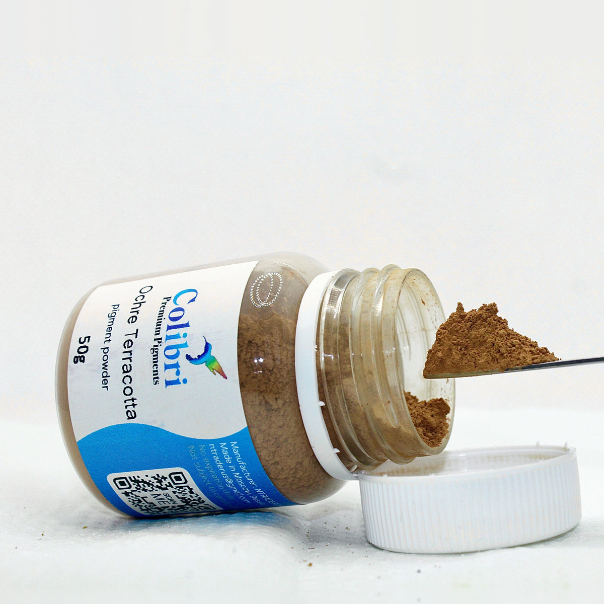Ochre terracotta pigment powder, open jar