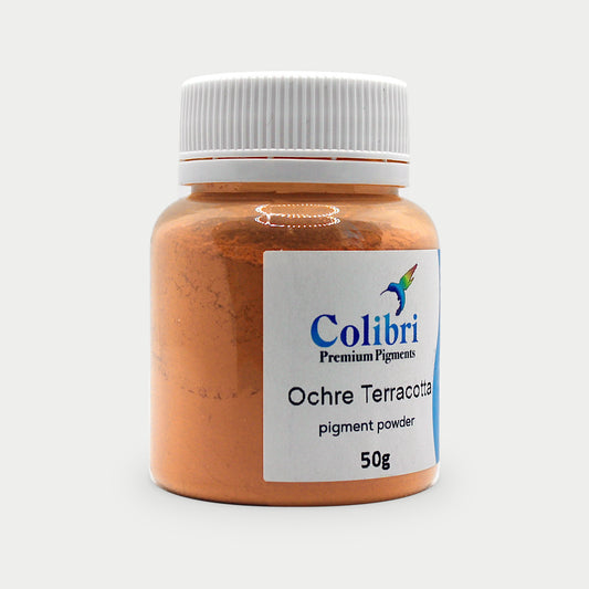 Ochre terracotta pigment powder in a Colibri jar