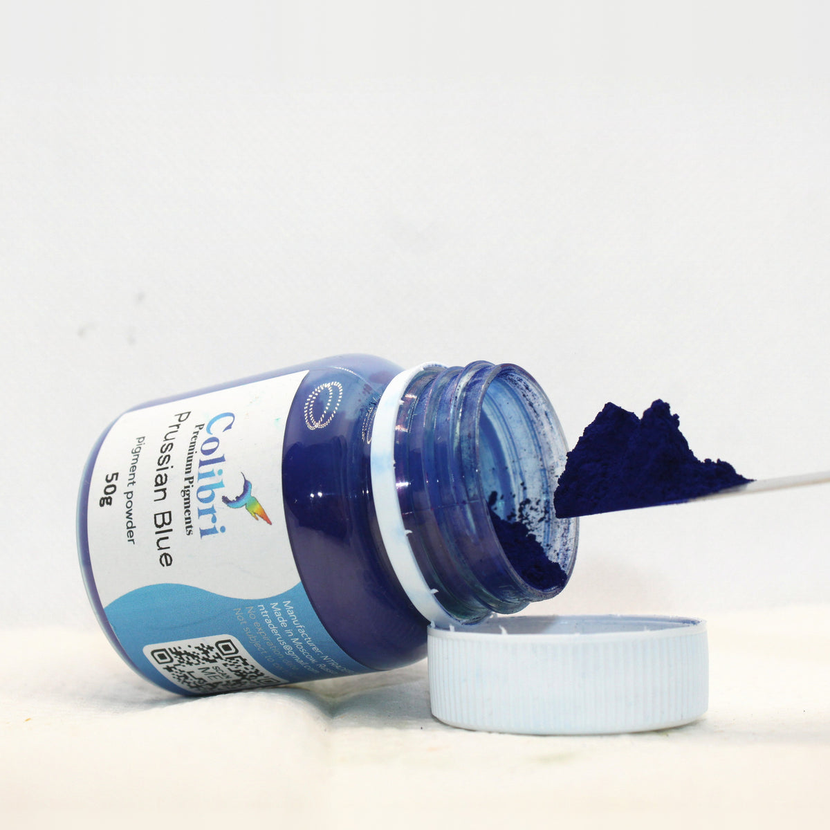 Prussian blue pigment powder, open jar