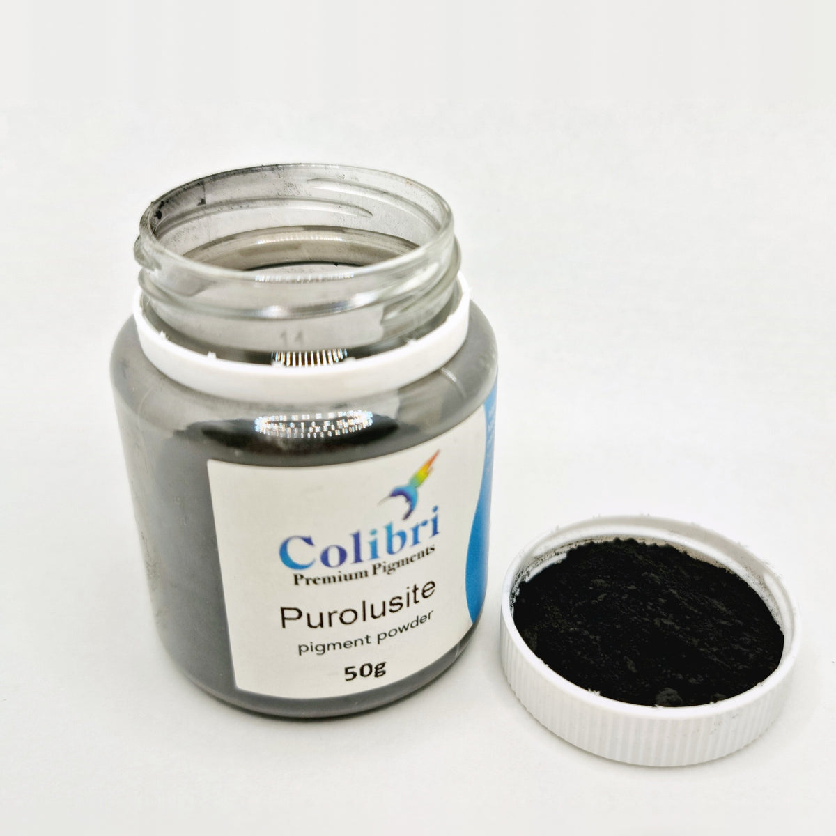 Pyrolusite pigment powder, open jar