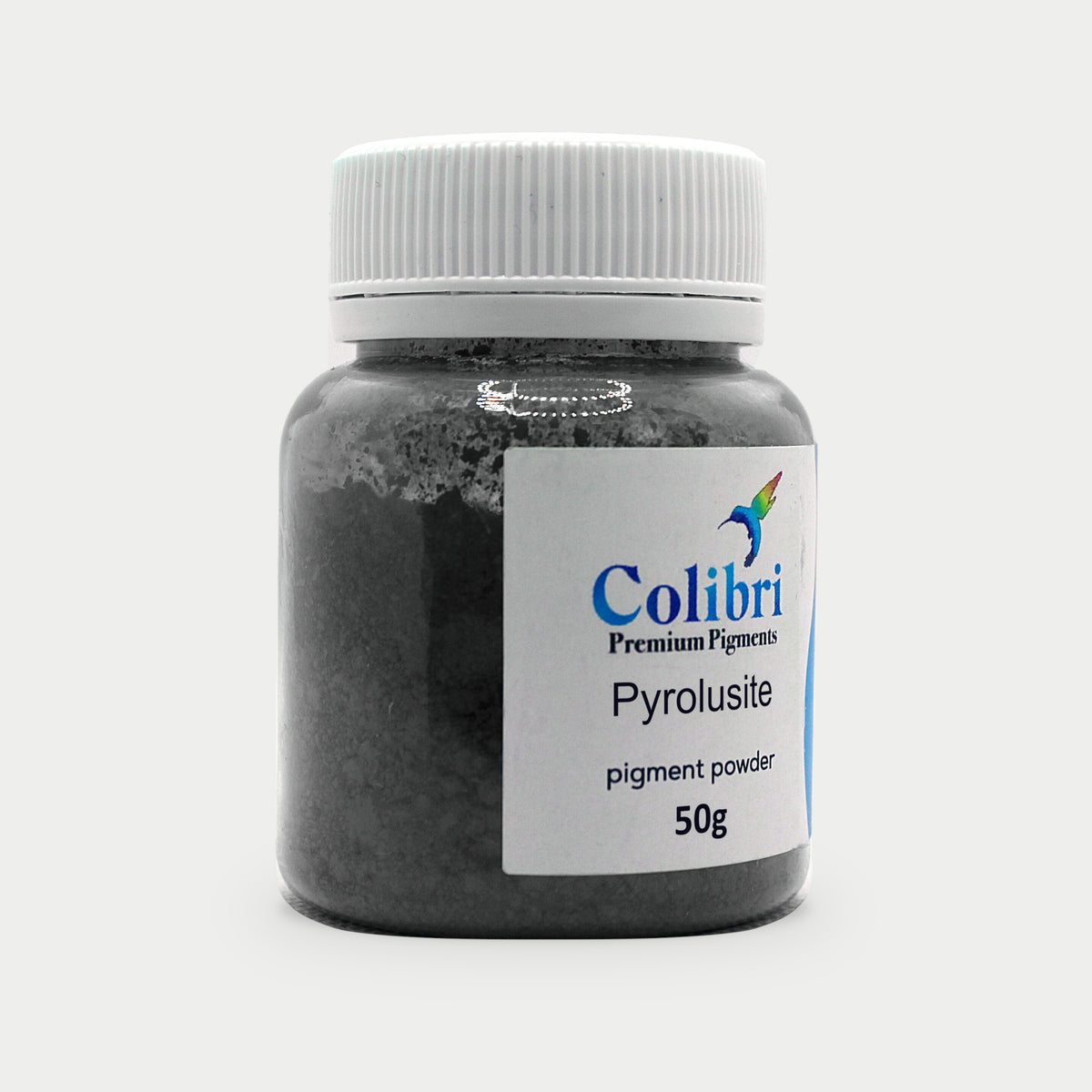 Pyrolusite pigment powder in a Colibri jar