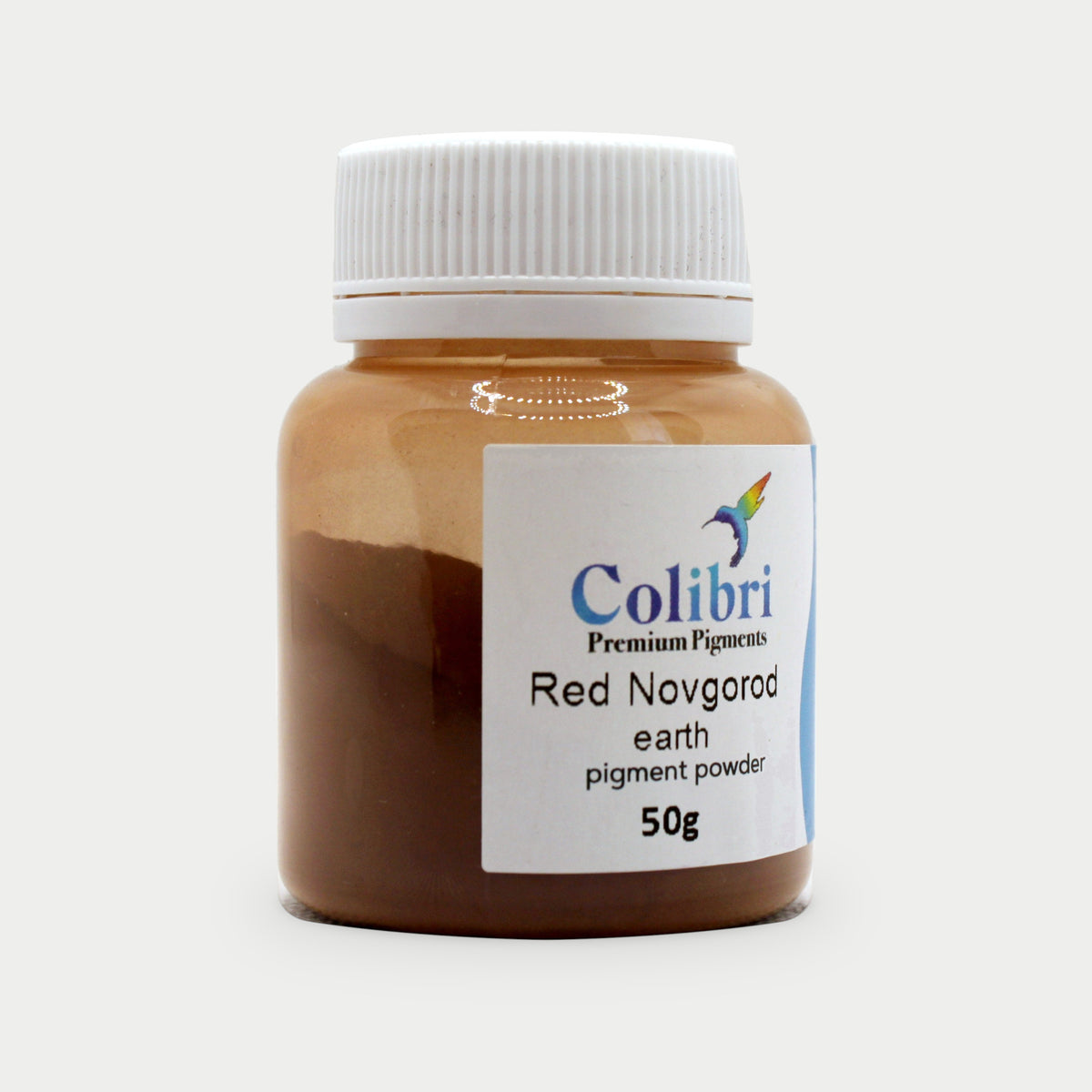 Red Novgorod earth pigment powder in a Colibri jar