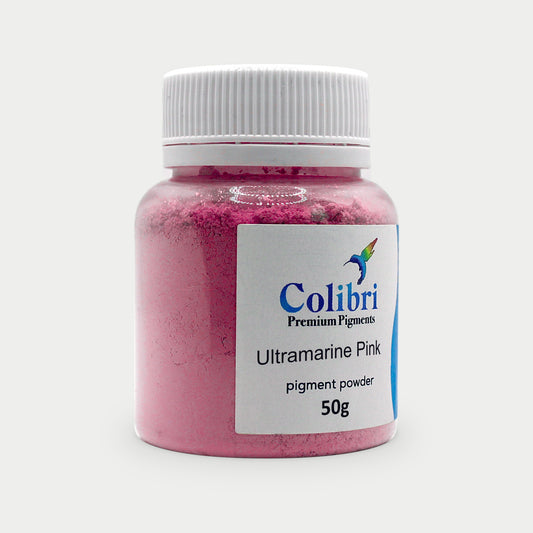 Ultramarine pink pigment powder in a Colibri jar