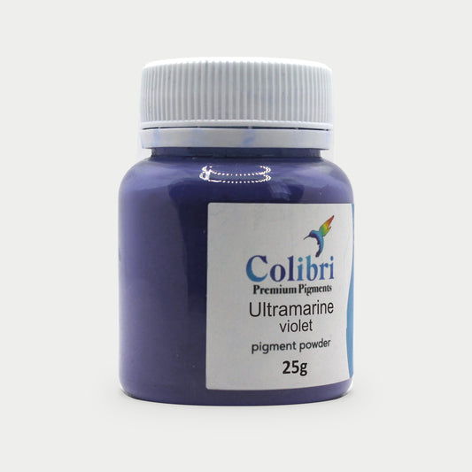 Ultramarine violet pigment powder in a Colibri jar