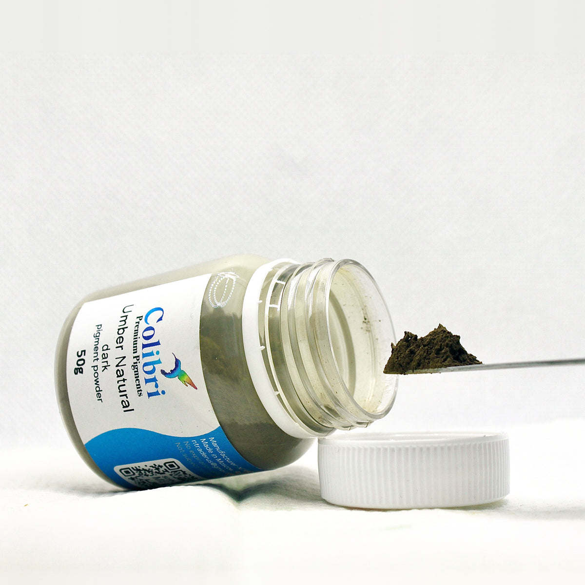 Umber natural dark pigment powder, open jar